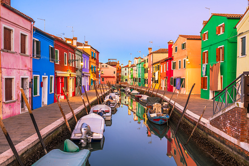 Burano, Venice, Italy colorful buildings along canals at twilight.