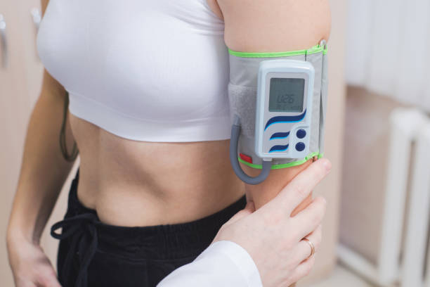 istock Bicycle Ergometry Electrocardiography, bicycle ergometer stress test. Athlete does a cardiac stress test in a medical study, monitored by the doctor 1417044051