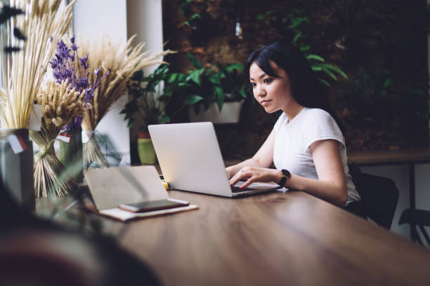 istock Puzzled lady typing on laptop at table 1417044618
