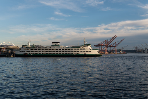 Seattle, USA - Aug 21, 2022: Elliott Bay on the waterfront as a Washington State Ferry crosses.