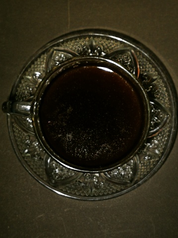 A glass of black coffee in a clear-colored cup. Coffee is suitable to be enjoyed in the morning in cold weather to warm the body