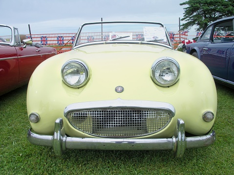 The front end of an Austin Healey Sprite at the Moncton British car show. The timeless classic roadster of a 50 year old automobile.
