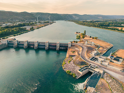 Water dam on the Rhone River and water filtration treatment plants. Overlooking the surrounding mountains in the Ardeche and the wind farm