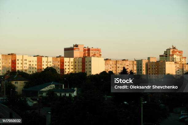 View Of The City From The Window Of The Apartment Sunset In The City And The View From The Window Houses Trees In The City At Sunset Stock Photo - Download Image Now