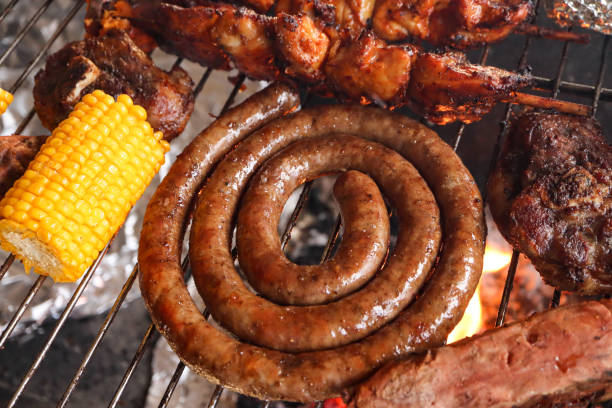 South African braai Braai meat including boerewors sausage, lamb chops, chicken kebabs and a mielie. Corn on the cob south african braai stock pictures, royalty-free photos & images