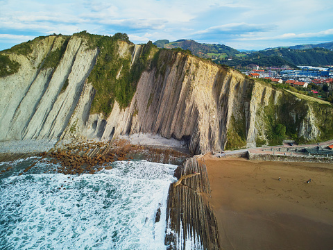 Aerial drone view of famous flysch of Zumaia, Basque Country, Spain. Flysch is a sequence of sedimentary rock layers that progress from deep-water