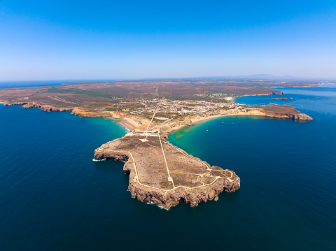 Aerial view, from south, of Sagres Cape, Fortress and Village. Tonel Beach can be seen in the left, while Mareta and Martinhal beaches are on the right. Sagres Point is a windswept shelf-like promontory located in the southwest Algarve region of southern Portugal.