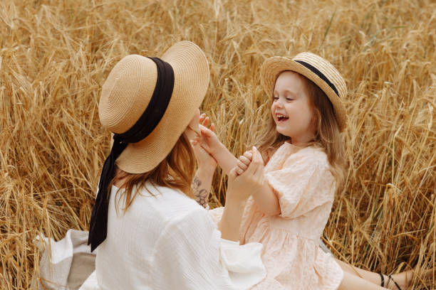 istock Mom and daughter in a wheat field 1417071883