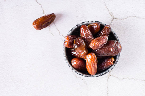 istock Ripe dried dates in a bowl on the table. Oriental dessert. Top view 1417072597