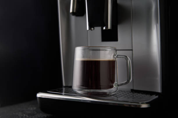 istock Freshly brewed coffee is poured from the coffee machine into glass cups. 1417072630
