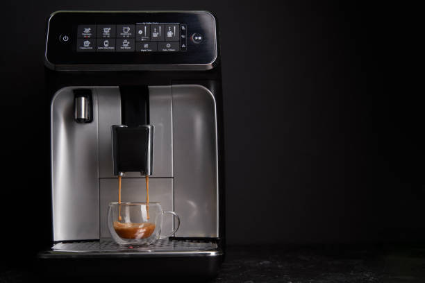 Freshly brewed coffee is poured from the coffee machine into glass cups. Freshly brewed coffee is poured from the coffee machine into glass cups. Professional coffee brewing at home. coffee maker in kitchen stock pictures, royalty-free photos & images