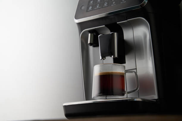 istock Freshly brewed coffee is poured from the coffee machine into glass cups. 1417072680
