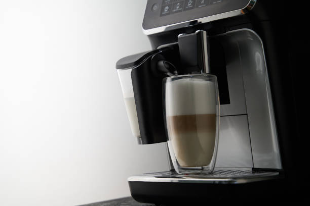 istock Freshly brewed latte is poured from the coffee machine into glass cups. 1417072722