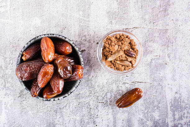 istock Bowl with date pit powder for making coffee on the table. Caffeine Free Alternative to Coffee. Top view 1417072741