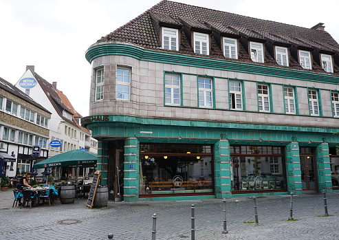 Bielefeld, NRW, Germany - July 23 2017 This corner house is located in Bielefeld's old town. Its called Kachelhaus (tile house) because of the cladding of the facade with  green porcelain tiles.