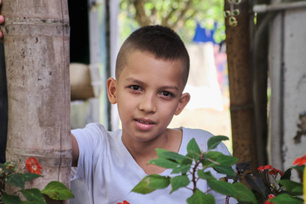 peasant boy on farm looking at the camera