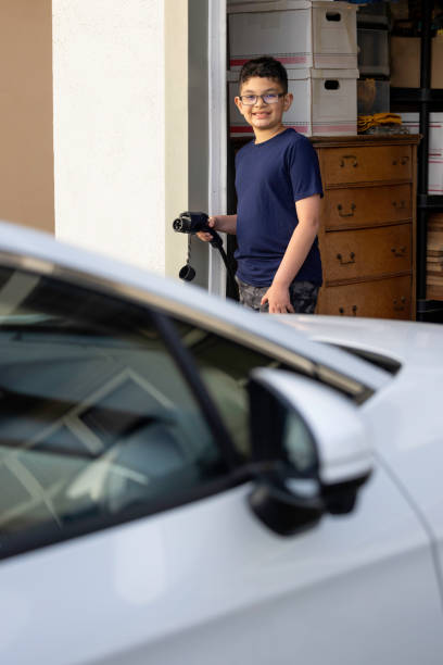 istock Child Charging Electric Car 1417077156