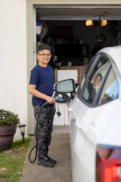 istock Child Charging Electric Car 1417077167