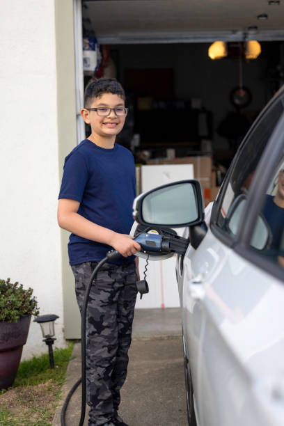 istock Child Charging Electric Car 1417077169