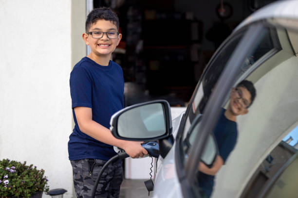 istock Child Charging Electric Car 1417077171
