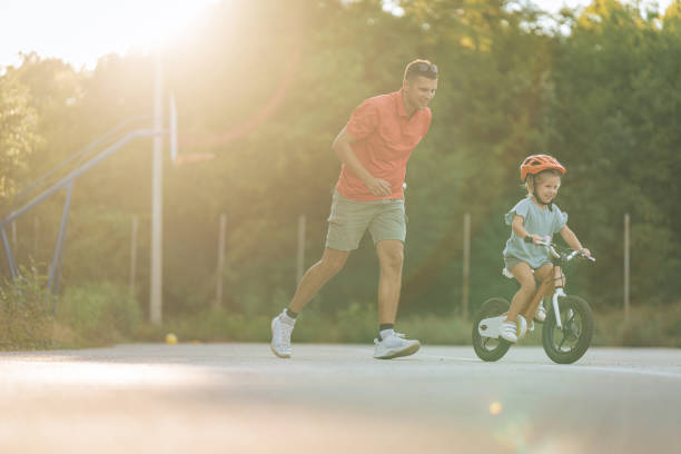 istock Little girl riding a bicycle 1417078731