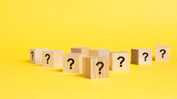 istock front view on many wood cubes with question marks. many question arising concept, yellow background 1417079100