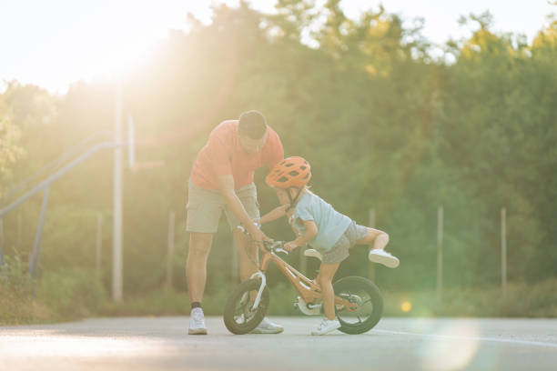 istock Girl getting on a bike 1417080850