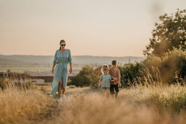 istock Mother and kids taking a walk in nature 1417082657