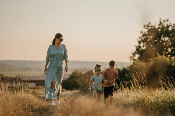 istock Mom and kids taking a walk in nature 1417082681