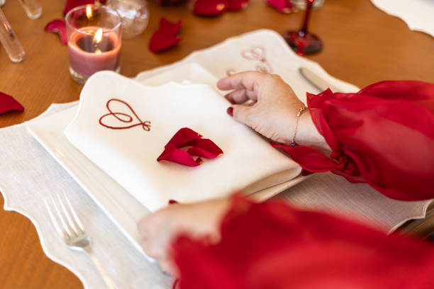 istock Valentine's themed serving plate and napkin holder, Close-up Video of Dinner Table with Empty Heart and Roses, Slow motion video of empty valentine's table during the Pandemic, dinner table service, serving cutlery and plates at the dinner table 1417084049