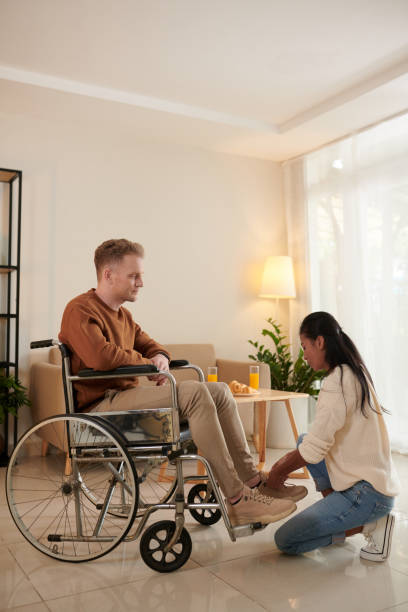 istock Caregiver Helping Young Man 1417084690