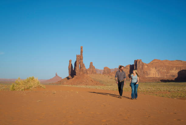 istock Couple walking during sunset in Monument Valley park, Utah 1417090768