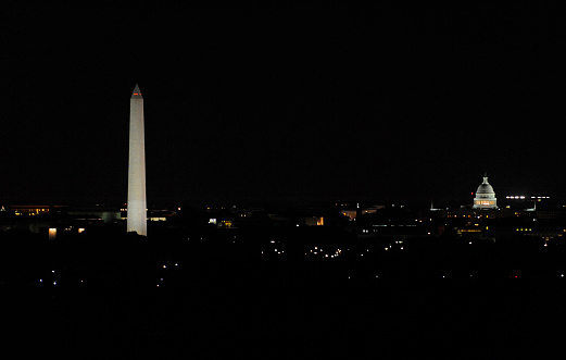 Sunset at the Washington Monument is an obelisk near the west end of the National Mall in Washington, D.C., built to commemorate the first U.S. president, General George Washington. The monument, made of marble, granite, and sandstone, is both the world's tallest stone structure and the world's tallest obelisk, standing 555 feet 5 inches (169.294 m).  It was designed by Robert Mills, an architect of the 1840s.