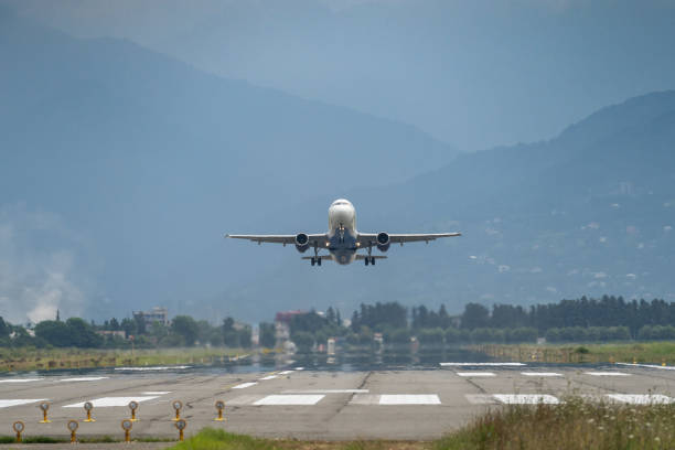 istock Airplane taking off from the airport, mountains on background. Transportation concept 1417093241