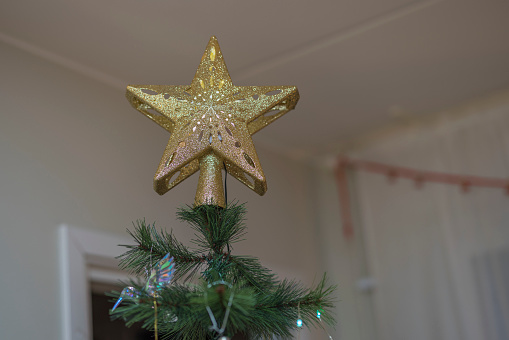 Close up view of lighting top star for Christmas tree decoration.