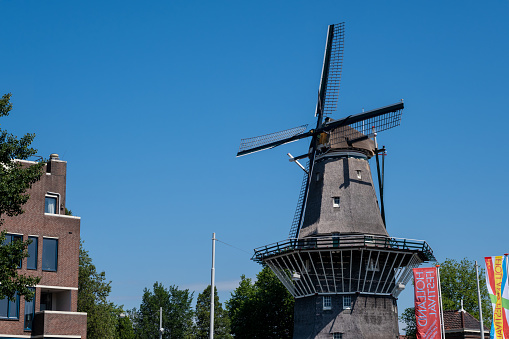 Amsterdam, The Netherlands - 23 June 2022: De Gooyer Windmill over blue sky