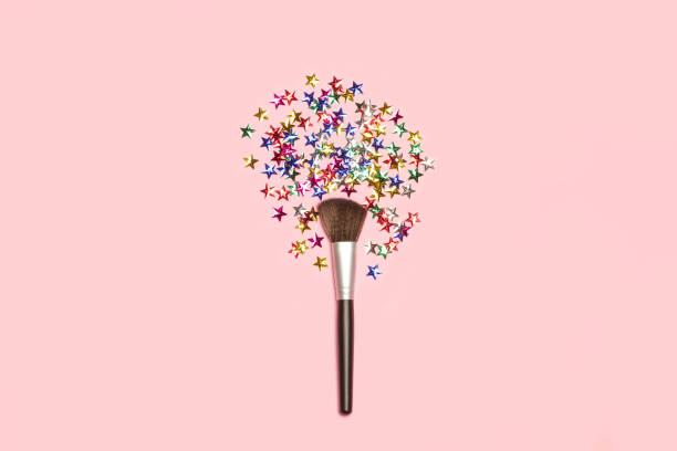istock Make up brush with colored stars on a pink background 1417094753