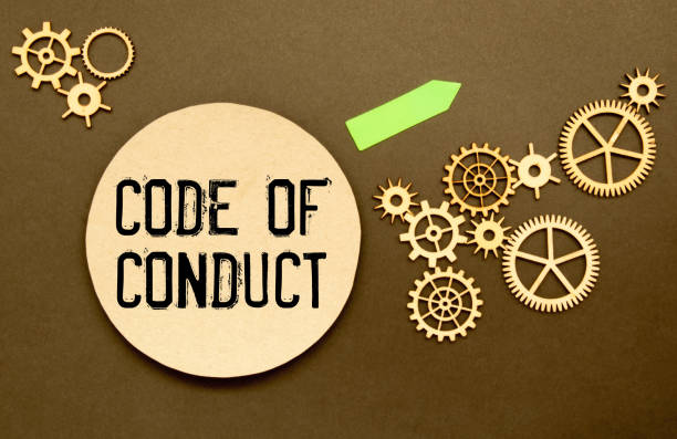 istock Business concept. Notebook with text CODE OF CONDUCT on pink paper with magnifier 1417095687