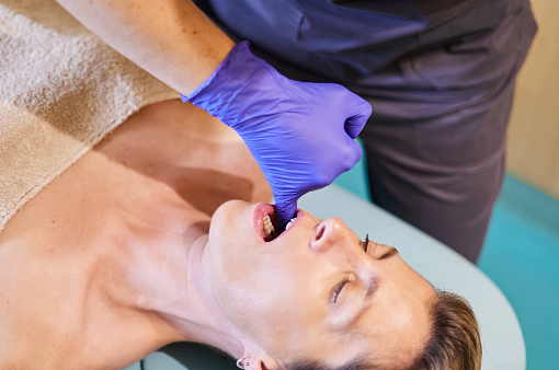 Osteopath performing the intraoral technique. Jaw correction. Maxillofacial