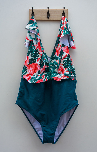 floral swimsuit on coat rack