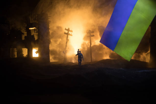 istock Silhouette soldier carrying little boy on his shoulder from fire. Rescue savior concept. Man moving out with little boy from burned out city destroyed in war. Selective focus 1417098461