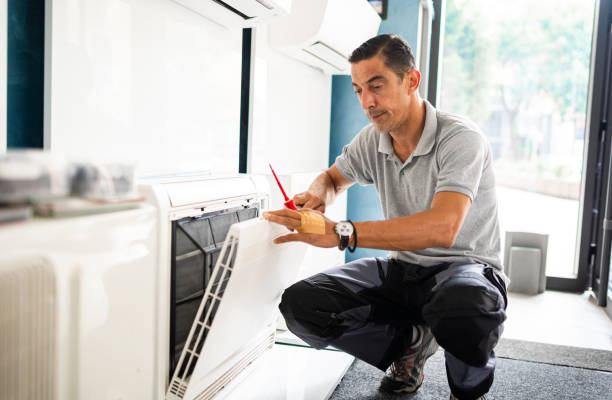 istock Repairman changing filter on air conditioner 1417100291