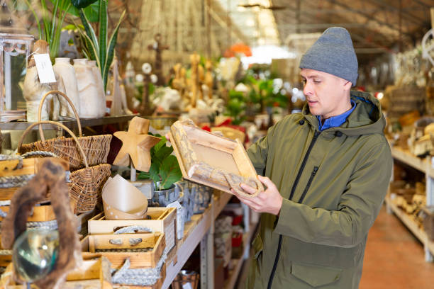istock Man choosing wooden box in decorative goods store 1417101272