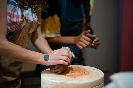 Adult Student Kneading ceramic dough at the Ceramic Workshop