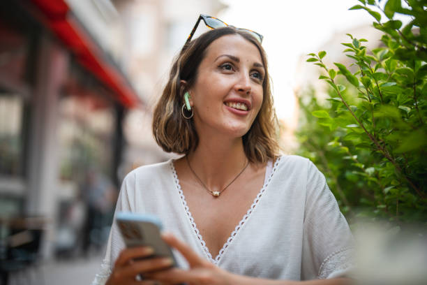 istock Happy Woman using Smartphone 1417107278