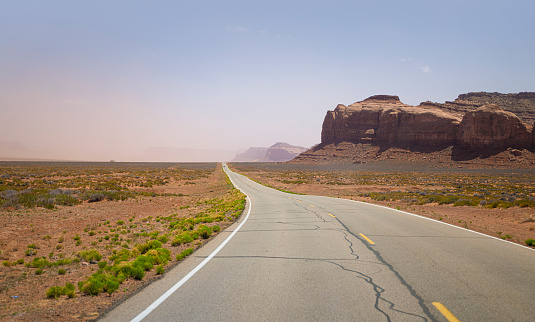 Empty single line road in Monument Valley, USA