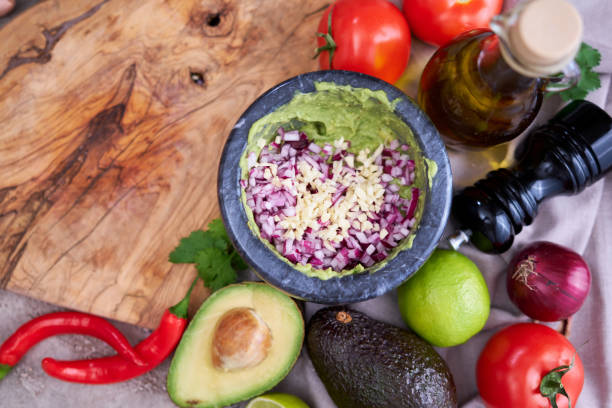 istock making guacamole - crushed avocado in marble mortar and ingredients 1417143517
