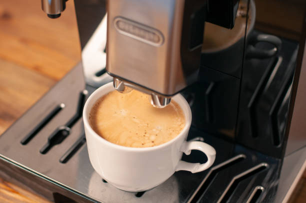 istock Espresso pouring from coffee machine, close up, professional coffee brewing. 1417143854