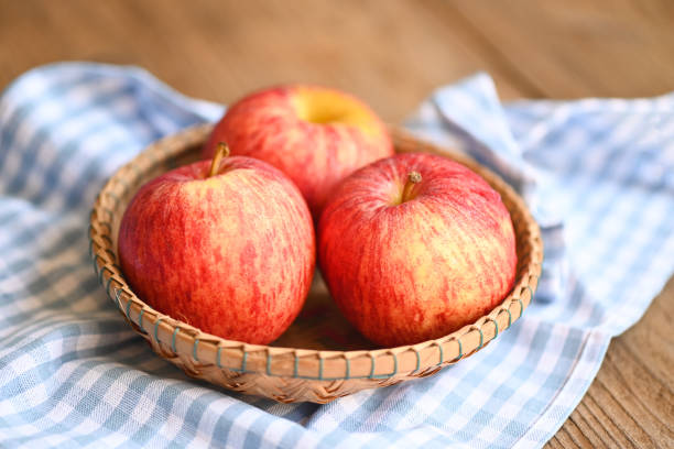 istock apple fruit on basket on the wooden table, ripe red apples 1417144477