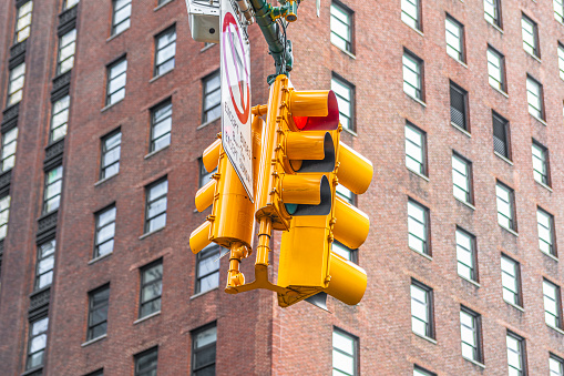 The yellow traffic light shows a red signal in the New York city center